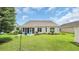 Lovely back exterior of home with a screened porch and patio area, manicured lawn, and tidy landscaping at 698 Lafayette Park Dr., Little River, SC 29566