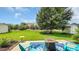Enjoy this outdoor space with a blue outdoor rug, gas fire pit, ample seating, and a view of the well-maintained landscaping at 698 Lafayette Park Dr., Little River, SC 29566