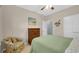 Cozy bedroom with ceiling fan, dresser, sitting chair, and a bed with an olive green cover at 698 Lafayette Park Dr., Little River, SC 29566