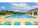 Community pool with blue water, lap lanes, lounge chairs and covered lounge area surrounded by mature trees at 698 Lafayette Park Dr., Little River, SC 29566
