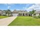 Lovely home with a well-kept lawn, complemented by mature palm trees at 698 Lafayette Park Dr., Little River, SC 29566