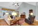 Relaxing living room features vaulted ceilings, a ceiling fan, and hardwood flooring at 698 Lafayette Park Dr., Little River, SC 29566