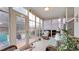 Bright sunroom with tiled floor, wicker furniture and access to backyard at 698 Lafayette Park Dr., Little River, SC 29566