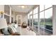 Charming sunroom with tiled floors, comfortable seating, and large windows offering a backyard view at 698 Lafayette Park Dr., Little River, SC 29566