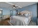 Bright and airy bedroom features a decorative ceiling fan, wood floors, and comfortable furnishings at 7601 N Ocean Blvd. # 7-C, Myrtle Beach, SC 29572