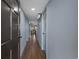 Hallway with wood floors leads to the living space with grey walls and stylish doors at 7601 N Ocean Blvd. # 7-C, Myrtle Beach, SC 29572