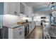 Modern kitchen with white cabinets, granite countertops, a wine fridge, and a spacious island at 7601 N Ocean Blvd. # 7-C, Myrtle Beach, SC 29572
