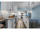Modern kitchen with white cabinets, granite countertops, a wine fridge, and a spacious island at 7601 N Ocean Blvd. # 7-C, Myrtle Beach, SC 29572