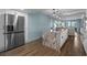 Bright kitchen with a large island, stainless steel refrigerator, and an open layout at 7601 N Ocean Blvd. # 7-C, Myrtle Beach, SC 29572