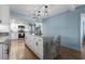 Renovated kitchen with a large island, white cabinets, and stainless steel appliances with plenty of counter space at 7601 N Ocean Blvd. # 7-C, Myrtle Beach, SC 29572