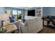 Cozy living room with an entertainment center, sliding glass doors, and comfortable seating at 7601 N Ocean Blvd. # 7-C, Myrtle Beach, SC 29572