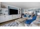 A modern living room with built in shelves, comfortable furniture, and an open kitchen area at 7601 N Ocean Blvd. # 7-C, Myrtle Beach, SC 29572