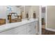 Well-lit bathroom featuring a white vanity with modern fixtures, a decorative mirror, and white countertop at 908 Pelagic Loop, Myrtle Beach, SC 29579