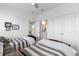 Bright bedroom showcasing two twin beds, ceiling fan, and ensuite bathroom access at 908 Pelagic Loop, Myrtle Beach, SC 29579