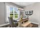 Bright dining room features a rustic table, window, stylish light fixture, and decor at 908 Pelagic Loop, Myrtle Beach, SC 29579