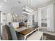 Open dining area features a rustic table, stylish light fixture, and lots of natural light at 908 Pelagic Loop, Myrtle Beach, SC 29579