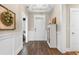 Inviting foyer with wood floors, wainscoting, and storage cabinet offering a warm and stylish welcome at 908 Pelagic Loop, Myrtle Beach, SC 29579