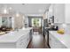 Modern kitchen features white cabinets, stainless steel appliances, quartz countertops, and wood flooring at 908 Pelagic Loop, Myrtle Beach, SC 29579