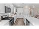 Modern kitchen boasting white cabinetry, stainless steel appliances, and sleek countertops for a seamless design at 908 Pelagic Loop, Myrtle Beach, SC 29579