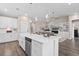 Open-concept kitchen with island and barstool seating seamlessly flowing into the adjacent living area at 908 Pelagic Loop, Myrtle Beach, SC 29579