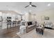 Open-concept living room features a gray sofa, decor, hardwood flooring, and an eat-in kitchen at 908 Pelagic Loop, Myrtle Beach, SC 29579