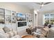 Cozy living room boasts built-in shelves, a fireplace, comfortable seating, and lots of natural light at 908 Pelagic Loop, Myrtle Beach, SC 29579