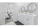 Bathroom featuring double sink vanity, tile floors, decorative mirrors, and access to the bedroom at 914 Mary Read Dr., North Myrtle Beach, SC 29582