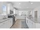 Bright, white kitchen features granite countertops, stainless appliances and open access to the living room at 914 Mary Read Dr., North Myrtle Beach, SC 29582