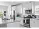 Modern kitchen featuring stainless steel appliances, granite counters, and white cabinets at 914 Mary Read Dr., North Myrtle Beach, SC 29582