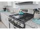 Close up of stainless steel stove with granite counters and white cabinets in this modern kitchen at 914 Mary Read Dr., North Myrtle Beach, SC 29582