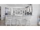 Kitchen bar featuring white cabinets, granite countertop, three bar stools, and modern appliances at 914 Mary Read Dr., North Myrtle Beach, SC 29582