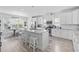Bright kitchen with white cabinets, granite counters, stainless steel appliances, and a large kitchen island at 914 Mary Read Dr., North Myrtle Beach, SC 29582