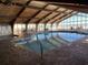 This is a view of the community indoor pool with lounge chairs and many windows at 9550 Shore Dr. # 1733, Myrtle Beach, SC 29579