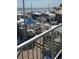 This is a view of an outdoor beach restaurant with chairs, tables, and umbrellas at 9550 Shore Dr. # 1733, Myrtle Beach, SC 29579
