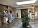 The photo shows a retail store with dresses, hats, clothing, and a palm tree at 9550 Shore Dr. # 1733, Myrtle Beach, SC 29579