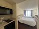 Well-lit bedroom with kitchenette, two beds and balcony access at 9550 Shore Dr. # 1733, Myrtle Beach, SC 29579