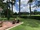 Beautiful backyard with lush lawn, mature trees, and brick patio, creating a serene outdoor space at 9614 Indigo Creek Blvd., Murrells Inlet, SC 29576