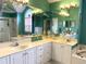 Bathroom featuring a double vanity, a large mirror, bright teal walls, and a walk-in shower at 9614 Indigo Creek Blvd., Murrells Inlet, SC 29576