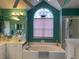 Bathroom featuring a tub, a double sink vanity, bright teal walls, and nautical decor at 9614 Indigo Creek Blvd., Murrells Inlet, SC 29576