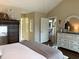 Bedroom boasts neutral paint, wood floors, a vaulted ceiling, and dressers with large mirrors at 9614 Indigo Creek Blvd., Murrells Inlet, SC 29576