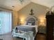 Bedroom with vaulted ceiling, sliding glass door, an upholstered headboard, and hardwood floors at 9614 Indigo Creek Blvd., Murrells Inlet, SC 29576