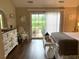 Bedroom with wood floors, a sliding glass door to the outside, neutral paint, and white painted furniture at 9614 Indigo Creek Blvd., Murrells Inlet, SC 29576