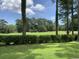 Scenic view of the golf course from the property, featuring lush green fairways and mature trees at 9614 Indigo Creek Blvd., Murrells Inlet, SC 29576