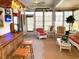 Relaxing sunroom with tropical themed decorations, wicker furniture, a ceiling fan, and several windows at 9614 Indigo Creek Blvd., Murrells Inlet, SC 29576