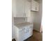 Modern kitchen featuring white cabinets, sleek hardware, and stylish backsplash at 982 Oak Hollow St., Longs, SC 29568