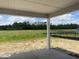 Backyard from a covered patio showcases expansive backyard with beautiful green trees and blue skies at 982 Oak Hollow St., Longs, SC 29568