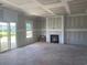 Unfinished living room with fireplace, sliding glass doors and bright window at 985 Oak Hollow St., Longs, SC 29568