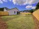A spacious backyard featuring a well-maintained lawn, wooden fence, and a cozy patio with a fire pit at 9888 Conifer Ln., Murrells Inlet, SC 29576