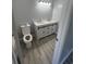 Bathroom with double sink vanity with drawers and cabinet doors, updated light fixtures, and white toilet at 9888 Conifer Ln., Murrells Inlet, SC 29576