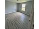 Neutral bedroom with laminate flooring and natural light from a single window at 9888 Conifer Ln., Murrells Inlet, SC 29576